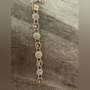 Mariana rose gold, pinkish purple stones with light teal color blue